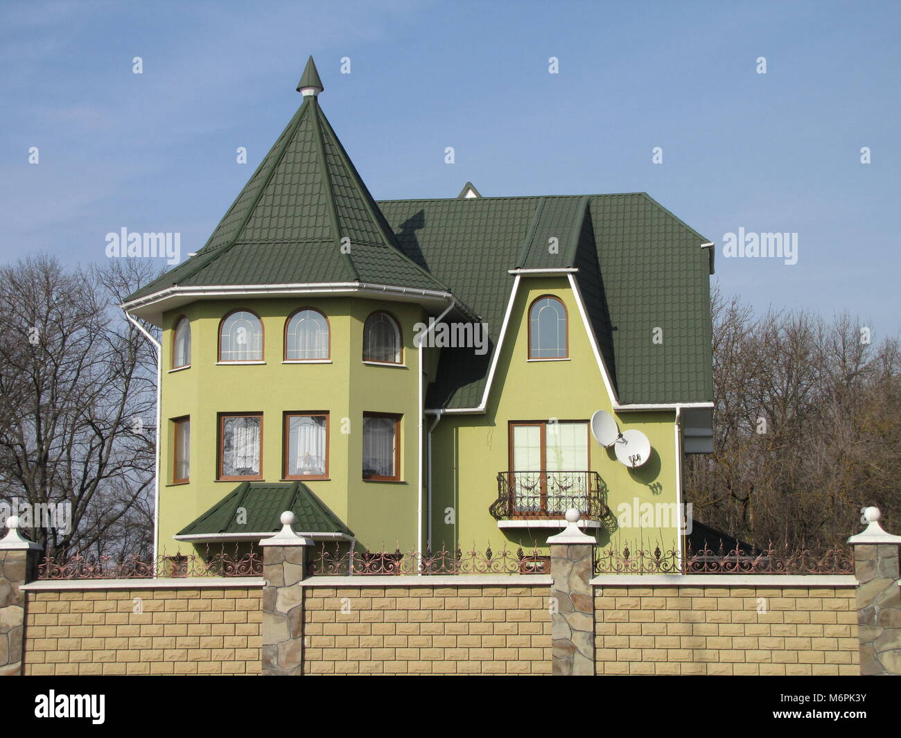 beautiful light green house with a green roof Stock Photo - Alamy