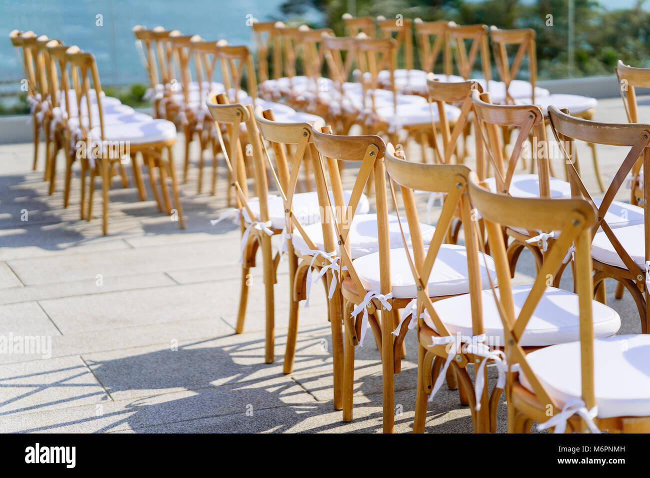 Folding lawn chairs line up for wedding venue Stock Photo
