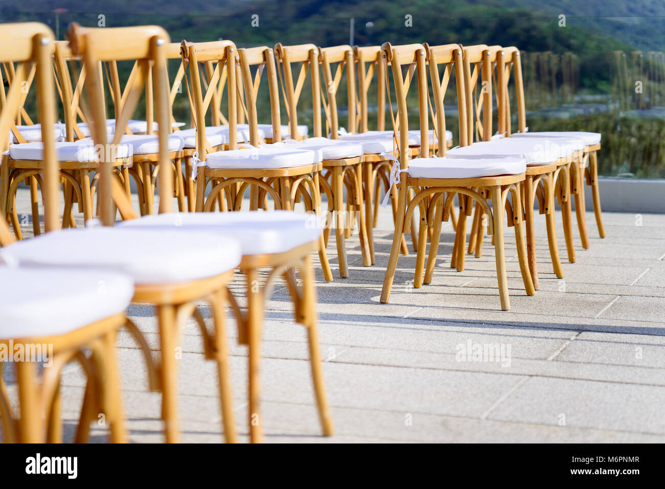 Folding lawn chairs line up for wedding venue Stock Photo