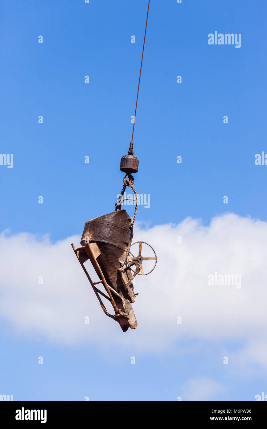 Construction industrial building site hanging bucket pouring concrete