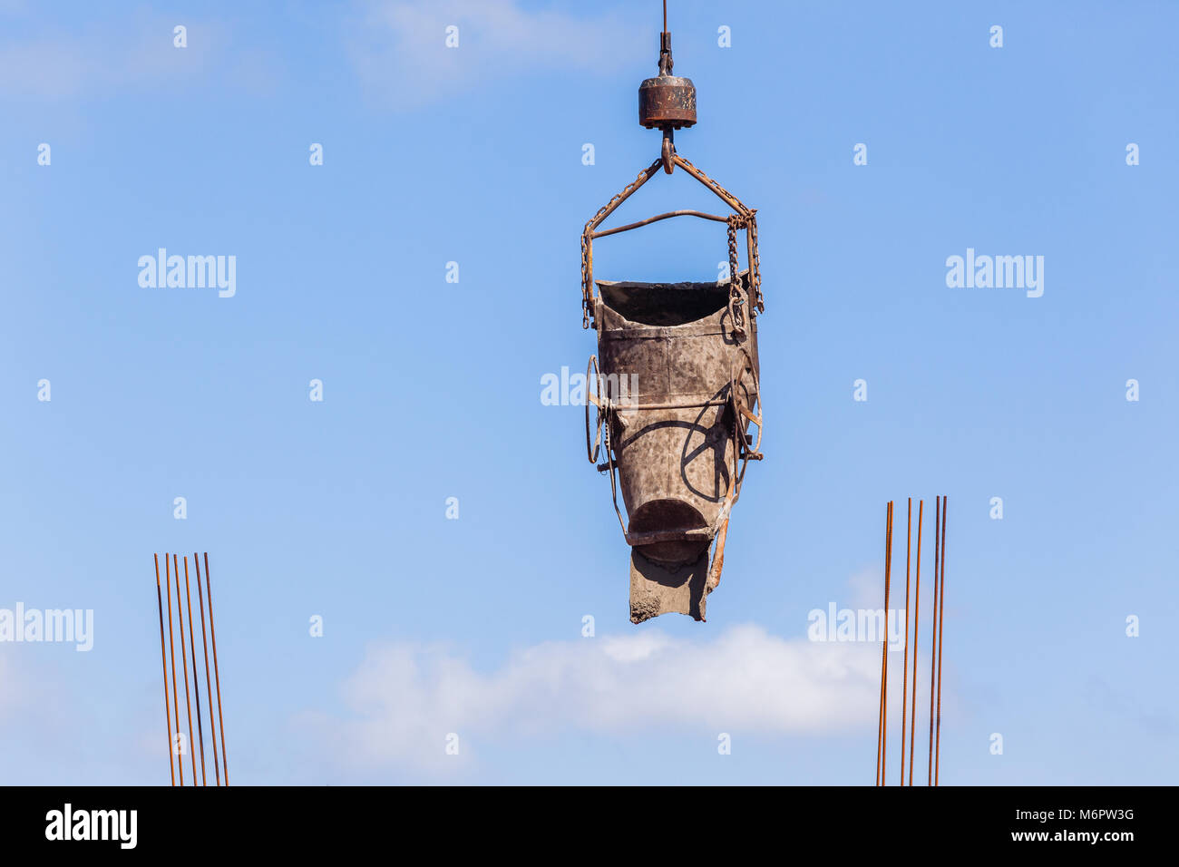 Construction industrial building site hanging bucket pouring concrete