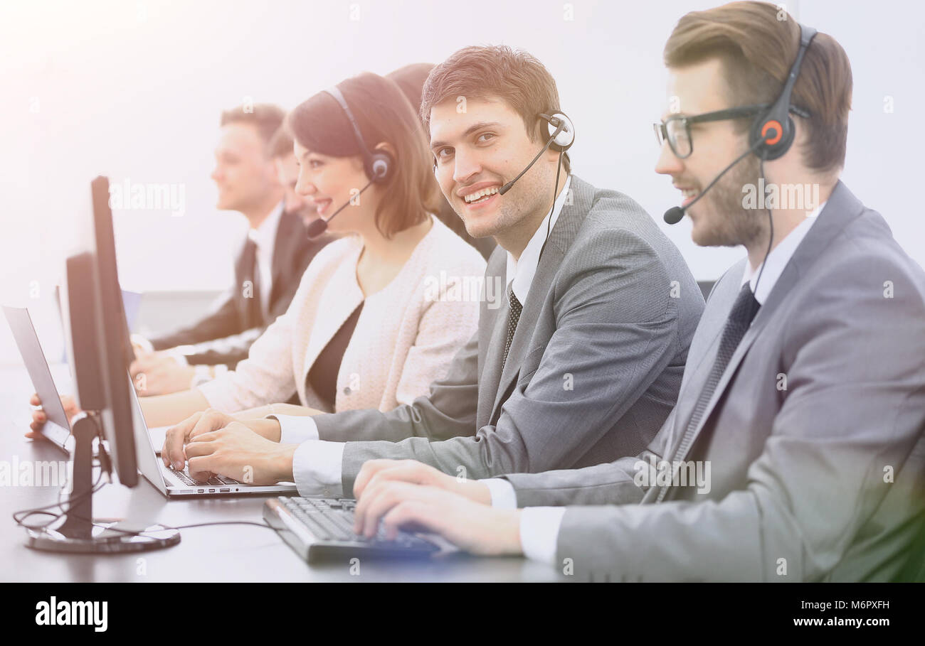 employee call center with headset at workplace Stock Photo