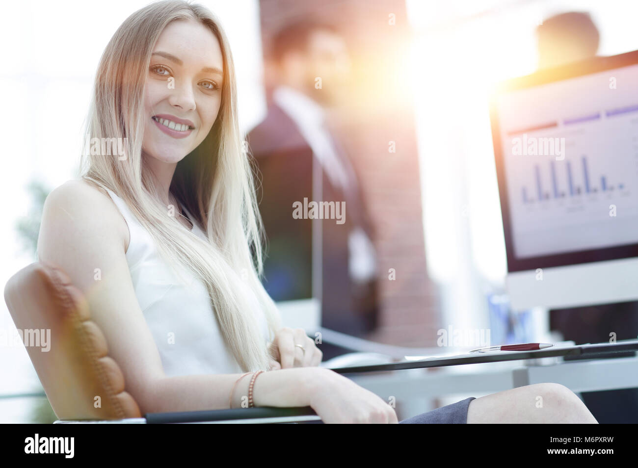 young business woman sitting at a desk in the office Stock Photo - Alamy
