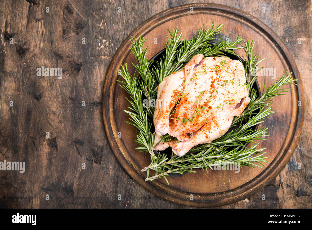 https://c8.alamy.com/comp/M6PY0G/whole-raw-chicken-on-wooden-cutting-board-raw-chicken-carcass-with-M6PY0G.jpg