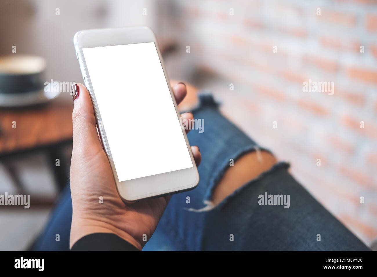 Mockup image of a woman's hand holding white mobile phone with blank ...