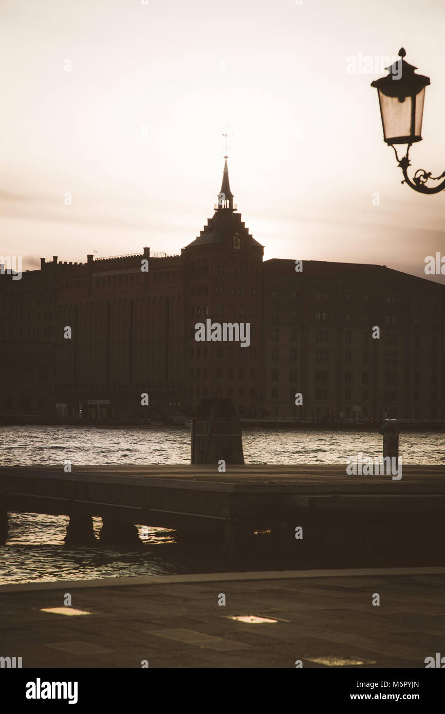 Winter sunset with silhouettes of palaces and churches in Venice, Italy ...