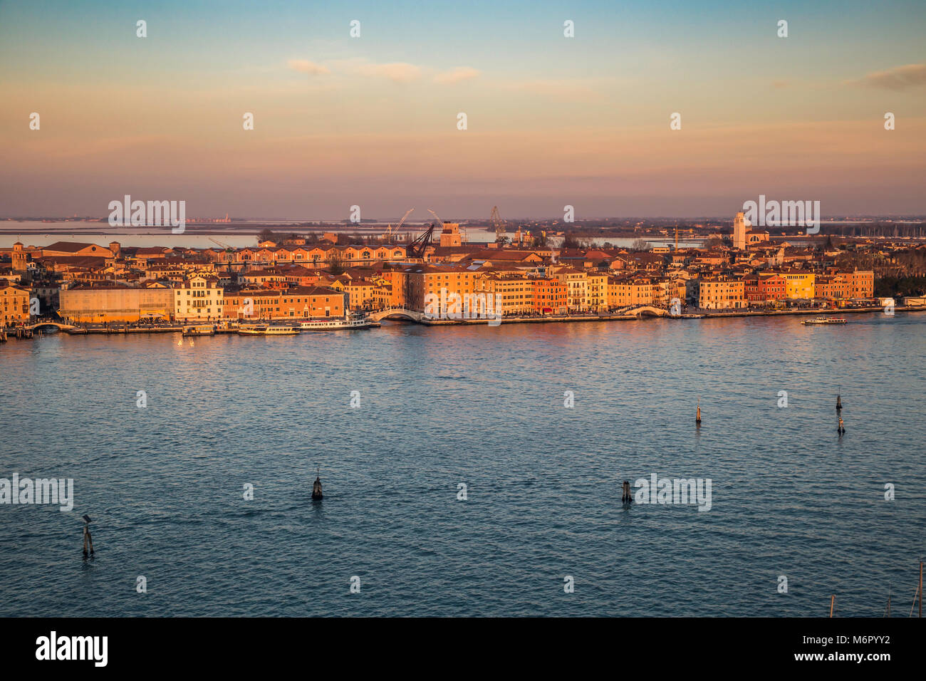 Aerial view of the city of Venice bathed in the winter sunset. View of the waterfront with palaces and tower churches. San Marco, Basilica Santa Maria Stock Photo