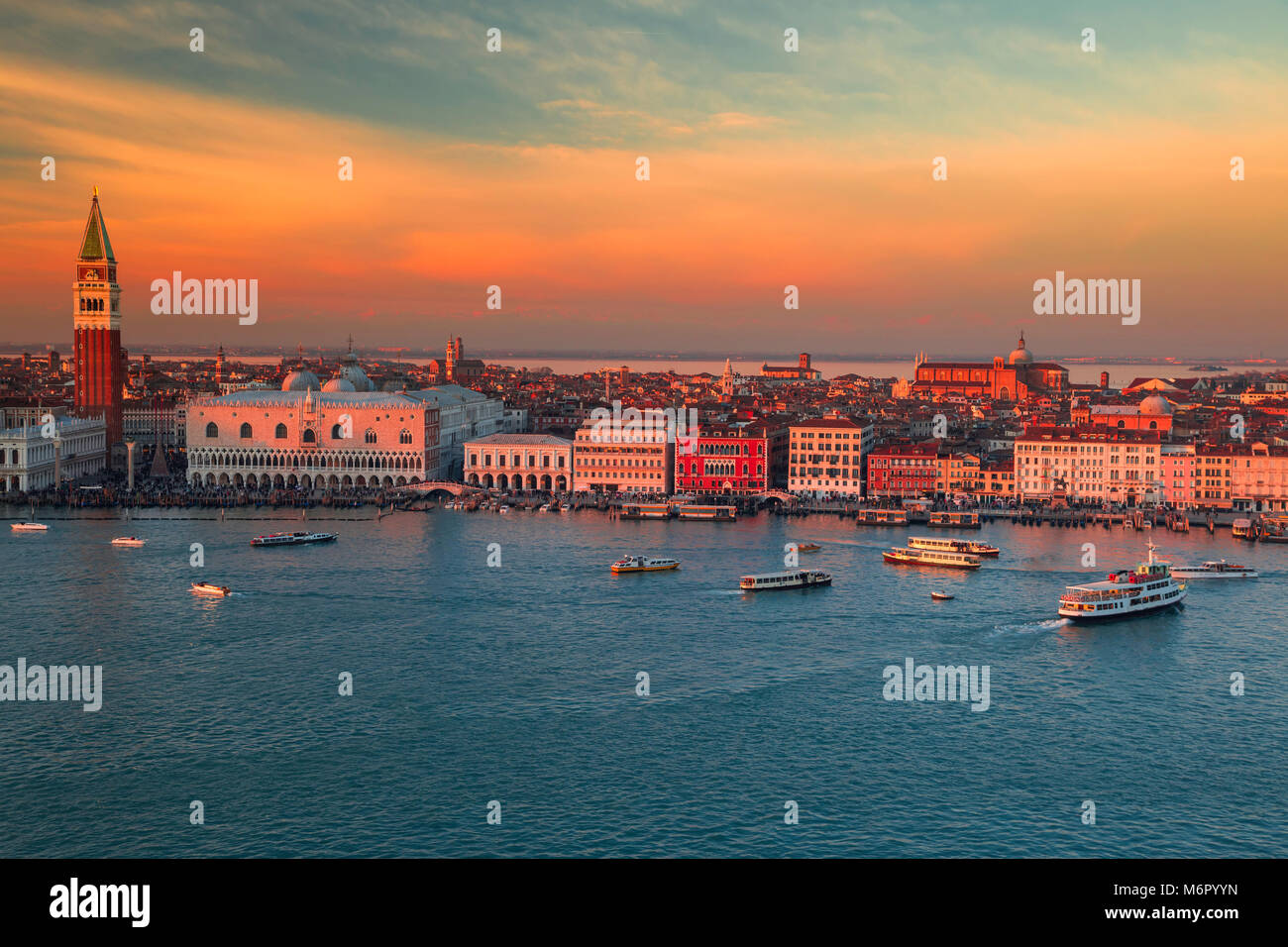 Aerial view of the city of Venice bathed in the winter sunset. View of the waterfront with palaces and tower churches. San Marco, Basilica Santa Maria Stock Photo