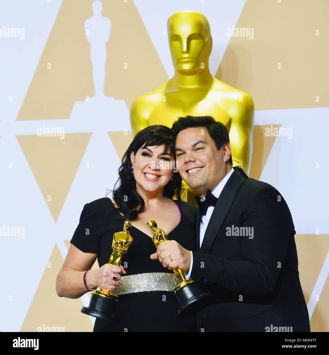 Song Writers Kristen Anderson-Lopez (L) and Robert Lopez winners of the Best Original Song for 'Coco' pose in the press room during the 90th Annual Academy Awards at Hollywood & Highland Center on March 4, 2018 in Hollywood, California Stock Photo