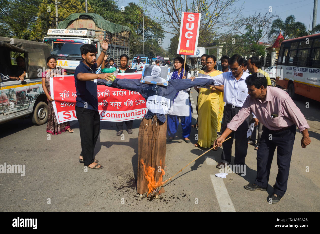 Activists of SUCI (C) (Socialist Unity Centre of India ) (Communist) Assam state committee burn down an effigy of Indian Prime Minister Narendra Modi during a protest against Vladimir Lenin statue demolished in Tripura. Stock Photo