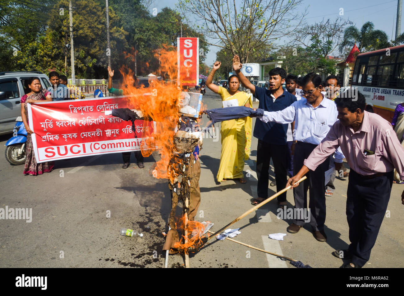 Activists of SUCI (C) (Socialist Unity Centre of India ) (Communist) Assam state committee burn down an effigy of Indian Prime Minister Narendra Modi during a protest against Vladimir Lenin statue demolished in Tripura. Stock Photo