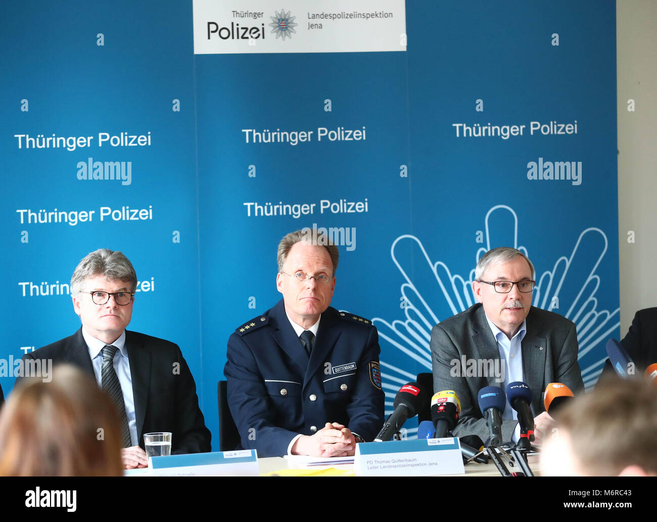 06 March 2018, Germany, Jena: Operation directors of the 'Cold cases' special commission, police director Lutz Schnelle (left to right), police director Thomas Quittenbaum, director of the Jena Police and Senior State Prosecutor Thomas Villwock speaking to the media during a press conference by the Jena Police. The reason for the press conference is the resolution of the 1991 case of Stephanie Drew's murder. A man suspected of the crime was arrested as part of the investigation. The case is the oldest of three cases of child murder in Jena and Weimar under investigation by the special commissi Stock Photo