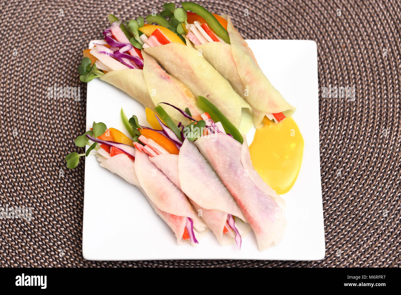 Homemade Korean pickled radish wraps with mustard source Stock Photo
