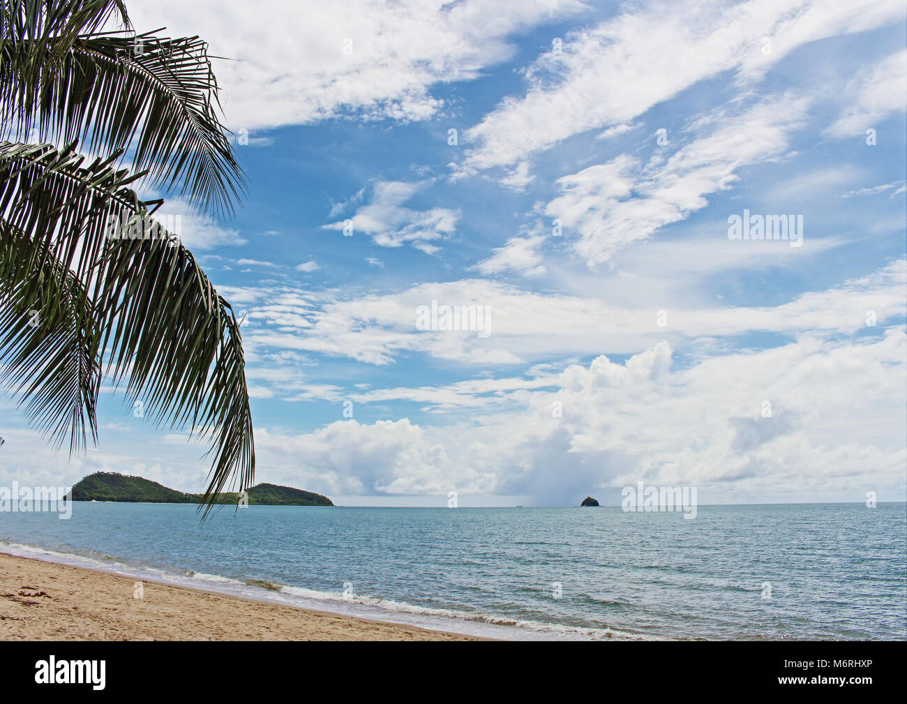 Palm Cove Beach view to double island and scout hat island as a tropical cyclone 'maybe' forms way out in the Coral Sea Stock Photo