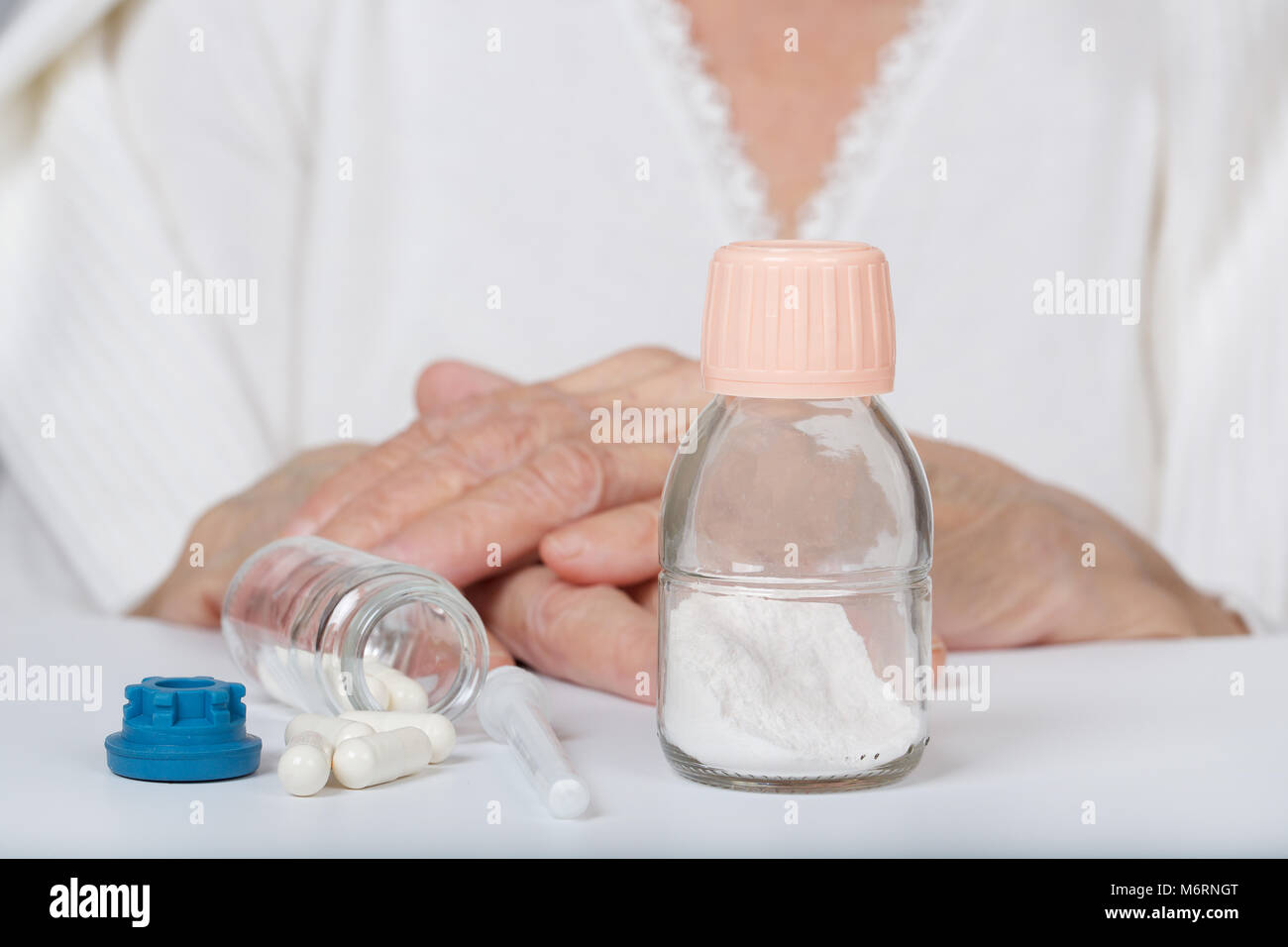 Antibiotics in powder in front of a senior woman Stock Photo