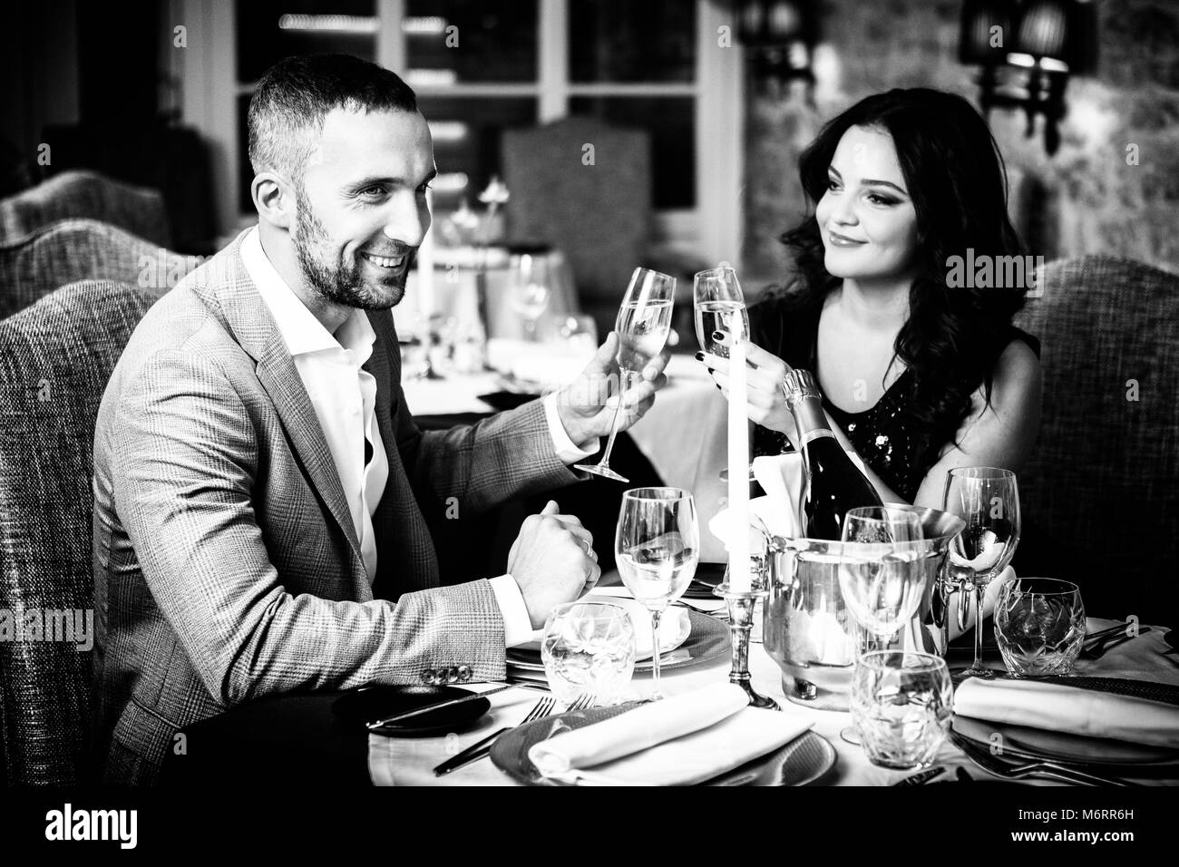 Couple celebrating in restaurant Stock Photo