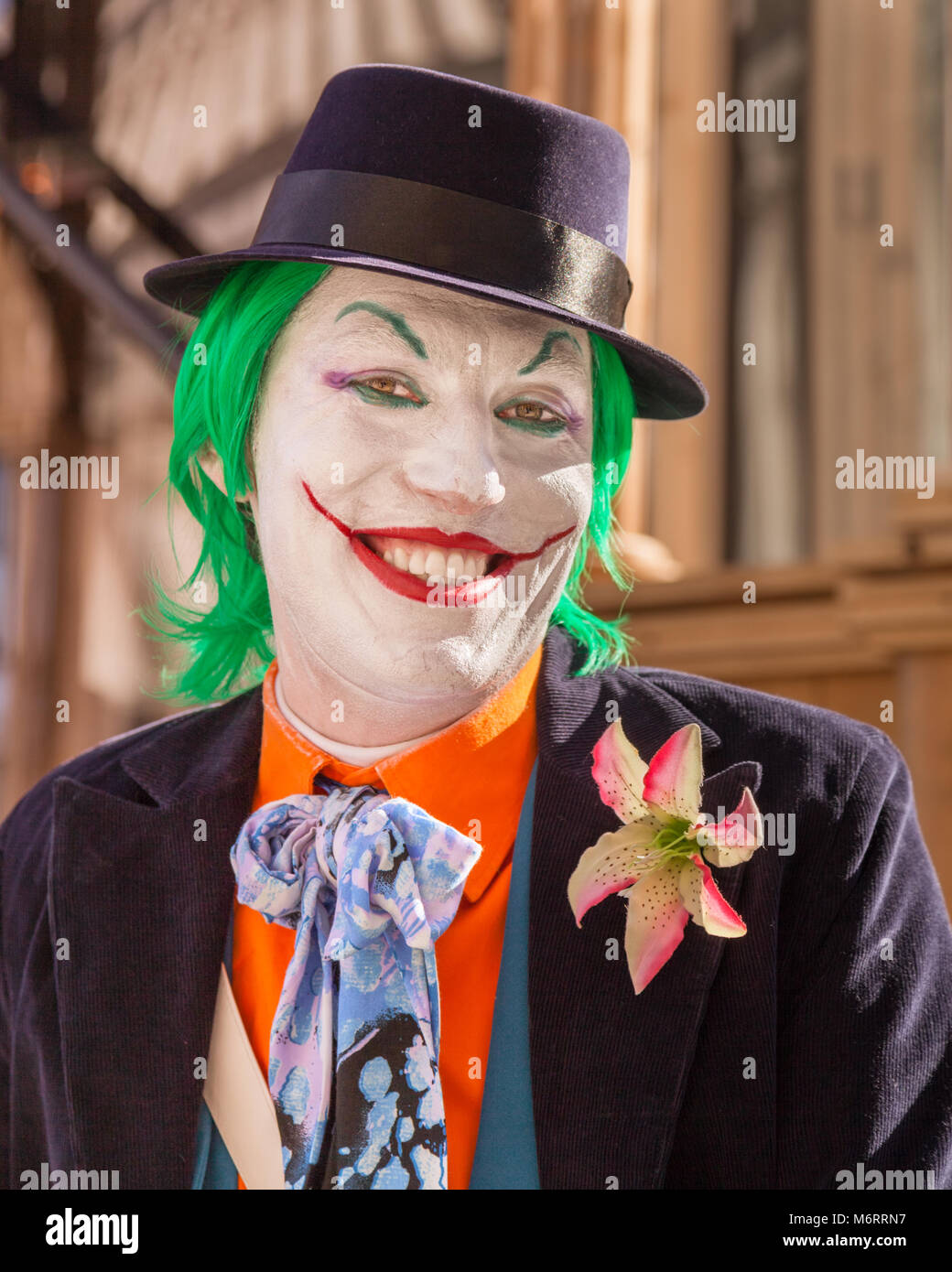 Clown face, participant in fancy dress costume as 'The Joker' from Batman, smiles at the Venice Carnival, Carnivale di Venezia, Veneto, Italy Stock Photo