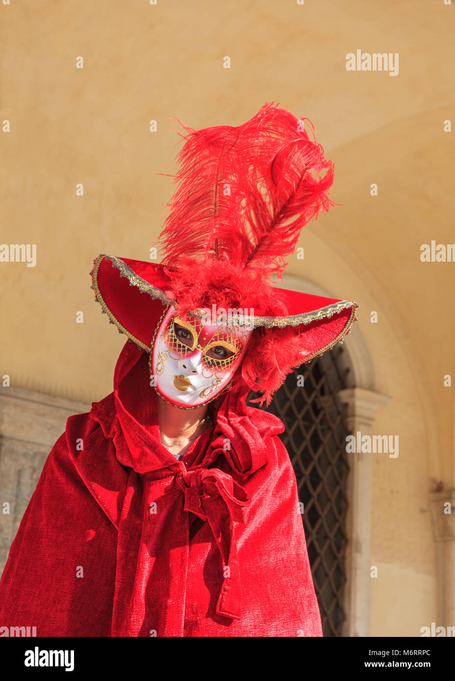 Woman in beautiful fancy dress costume dress, hat and mask poses at the Venice Carnival, Carnivale di Venezia, Veneto, Italy Stock Photo