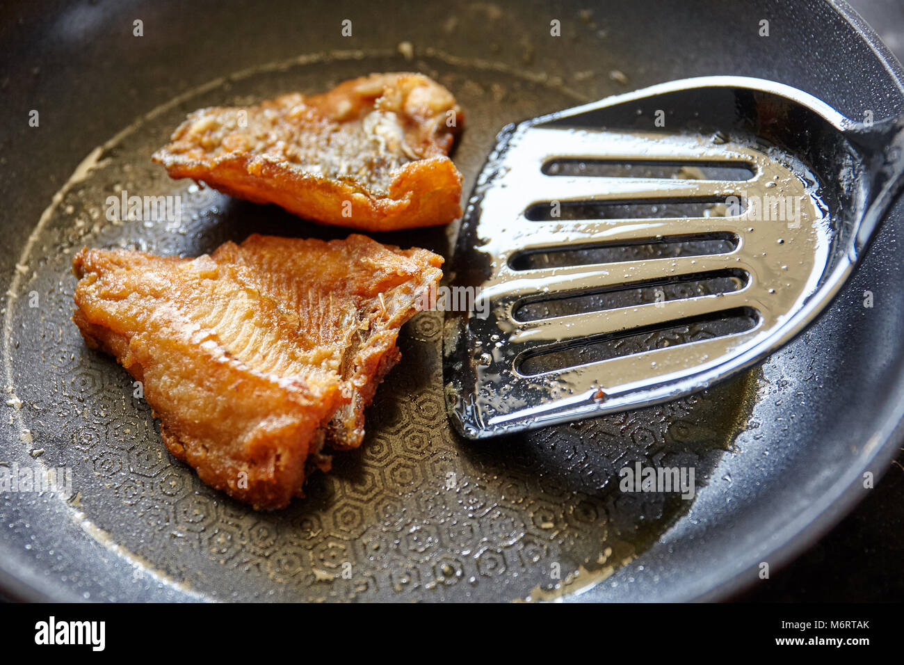 Cooking, Frying nile tilapia fish on the pan with oil Stock Photo Alamy