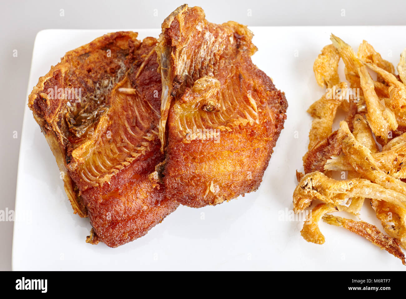 Tilapia fish fried and white bait fish fried close up, top view Stock