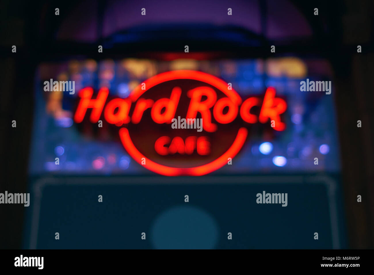 Blurred neon light of the logo of Hard Rock cafe at night. Stock Photo