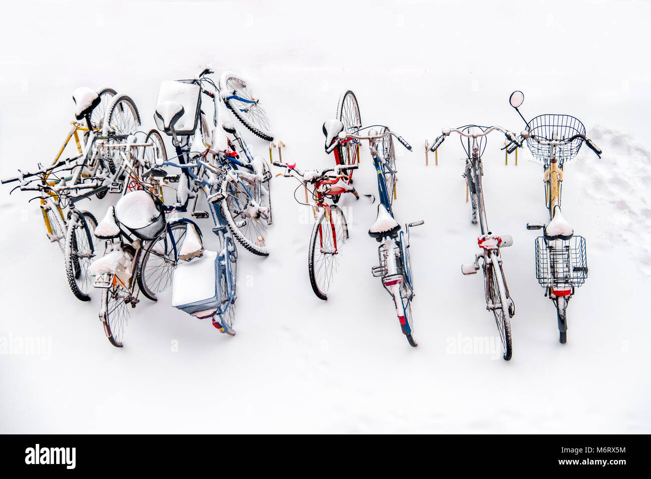 bikes in the snow - bicycles background white winter above view Stock Photo