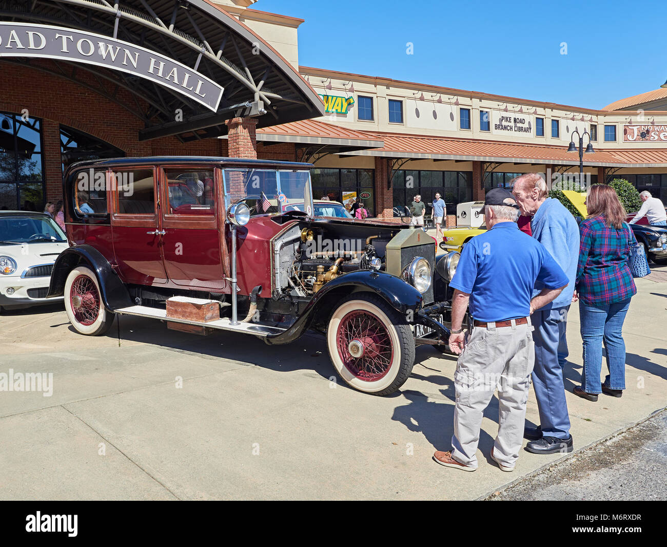 British classic car enthusiast looking over a 1924 Rolls Royce Silver Ghost limousine at a local car show in Pike Road, Alabama, USA. Stock Photo