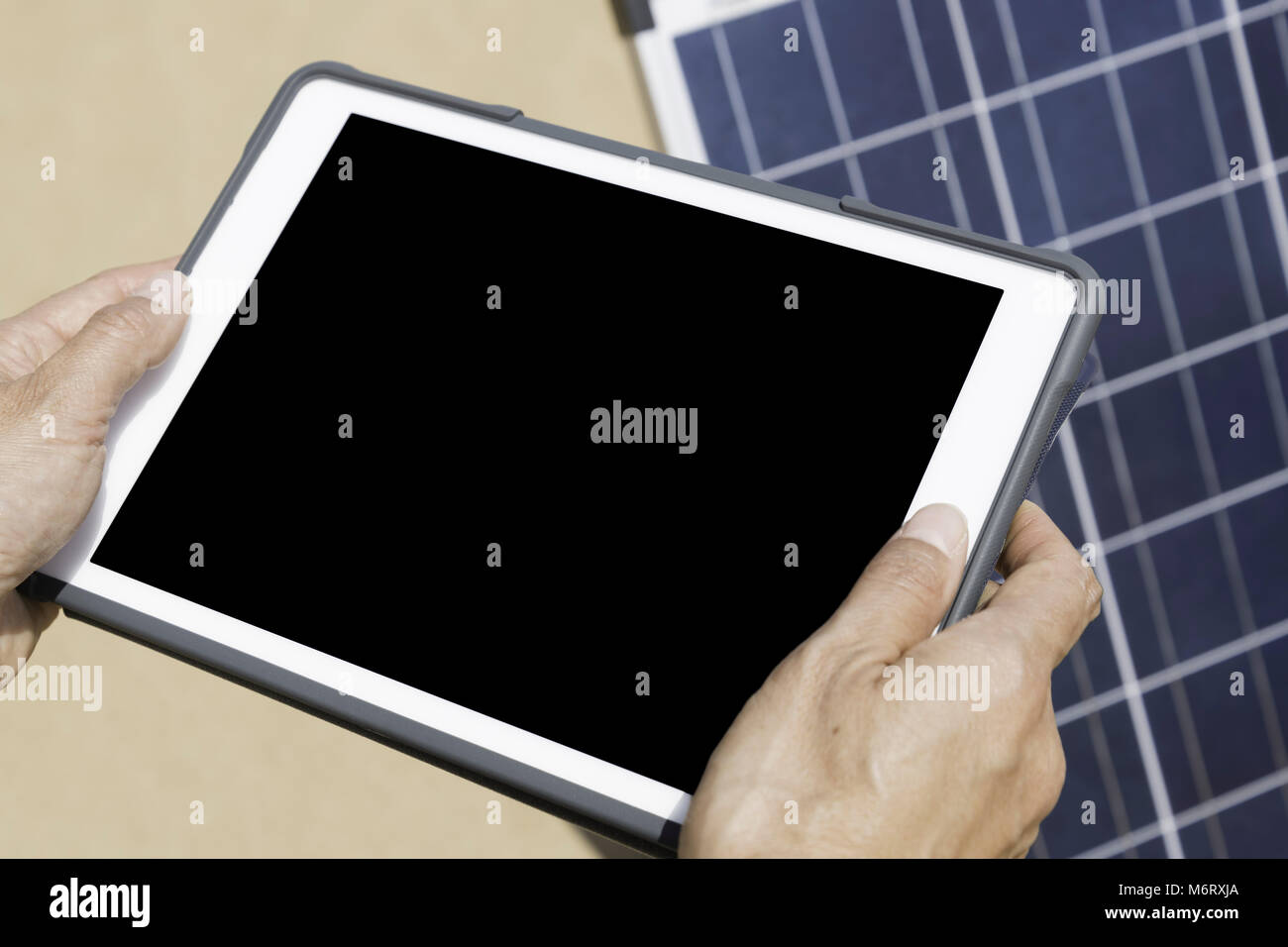 Tablet Using Solar Panel Woman hands on electronic tablet controlling her solar panel (black ...