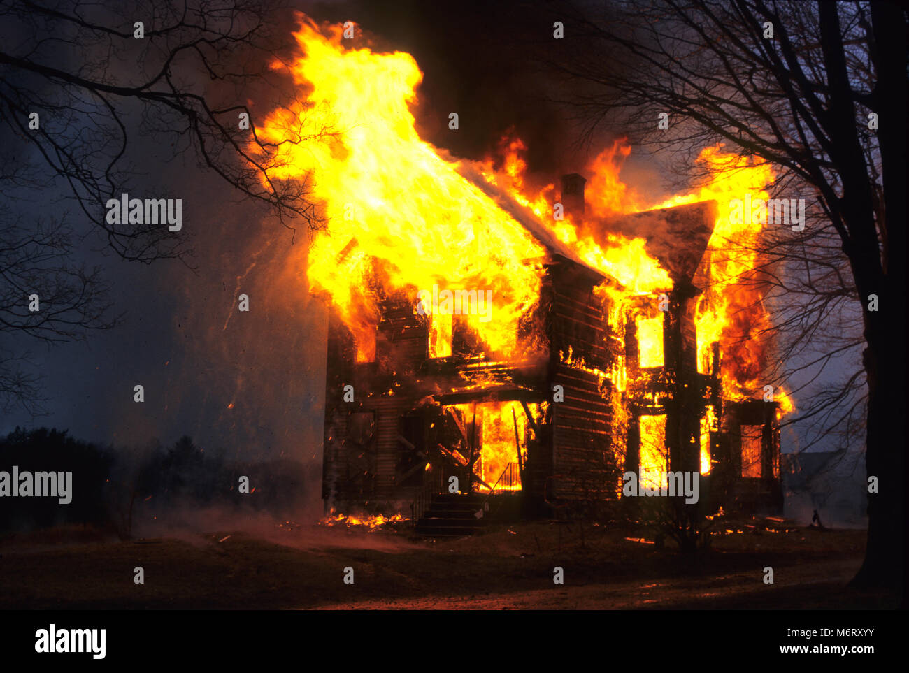 An abandoned building fully involved in flames Stock Photo
