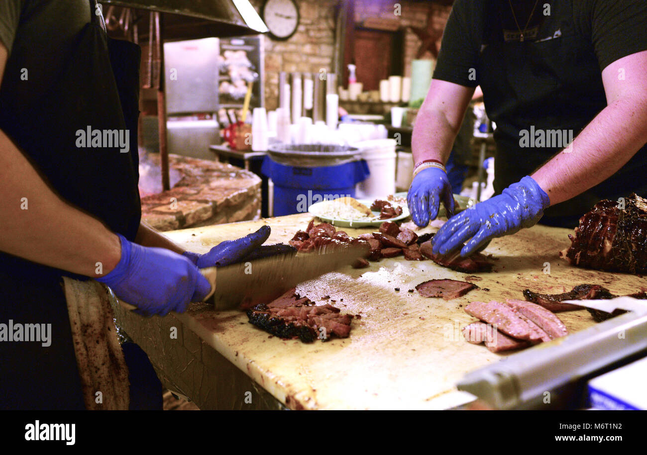 Meat smoking in open pit for bar-b-que Stock Photo