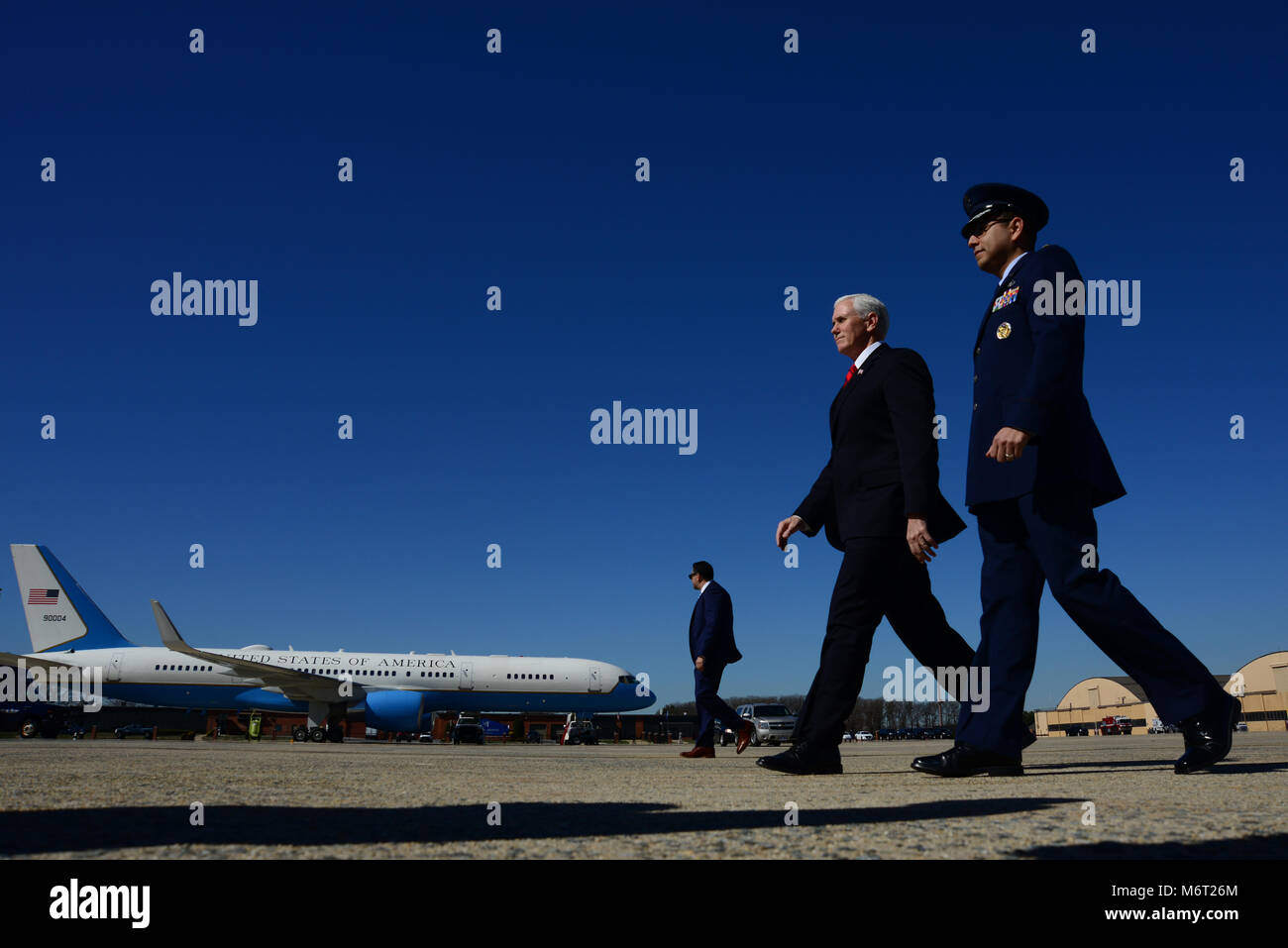Maj. Jeremy Tobias, 89th Airlift Wing director of flightline protocol, walks with Vice President Mike Pence to Air Force Two at Joint Base Andrews, Feb. 27, 2018. The 89th AW enables national interests through global transportation for America's senior leaders. (U.S. Air Force photo/Staff Sgt. Kenny Holston) Stock Photo