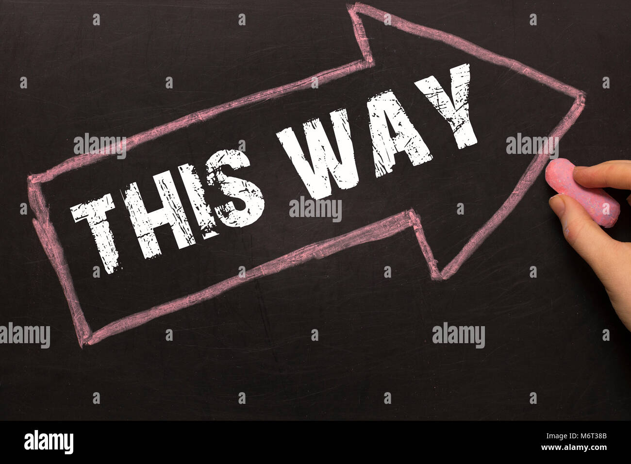 This way - Chalkboard with arrow on black background Stock Photo