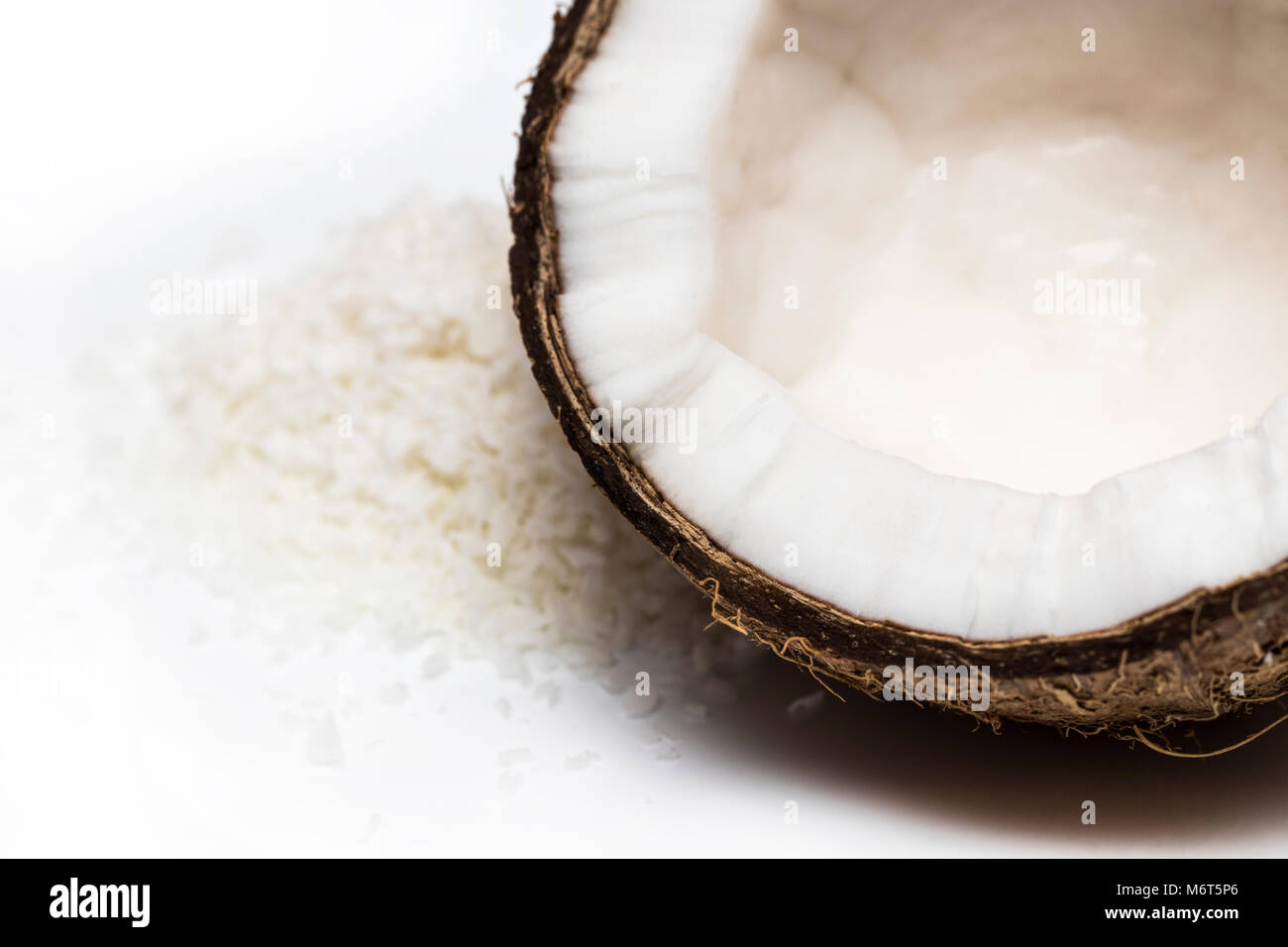 coconuts with coconuts flakes isolated on the white background Stock