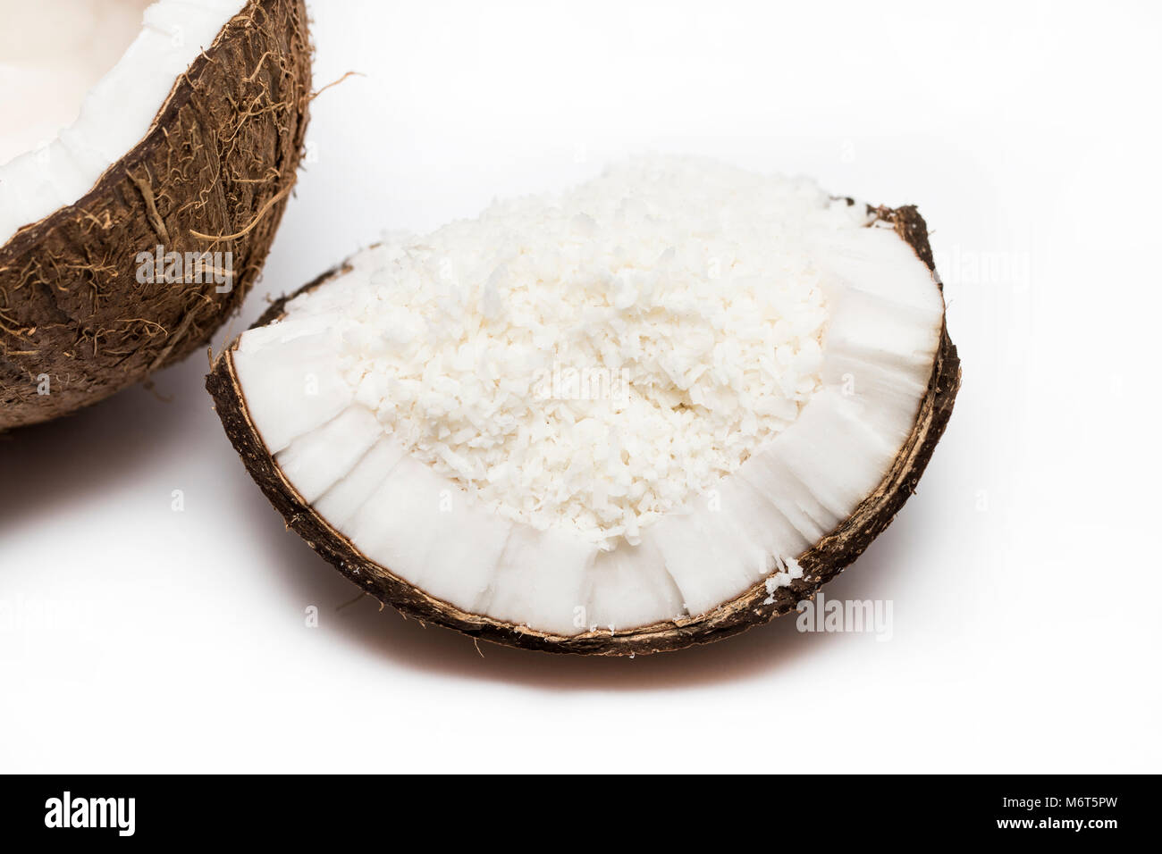 coconuts with coconuts flakes isolated on the white background Stock