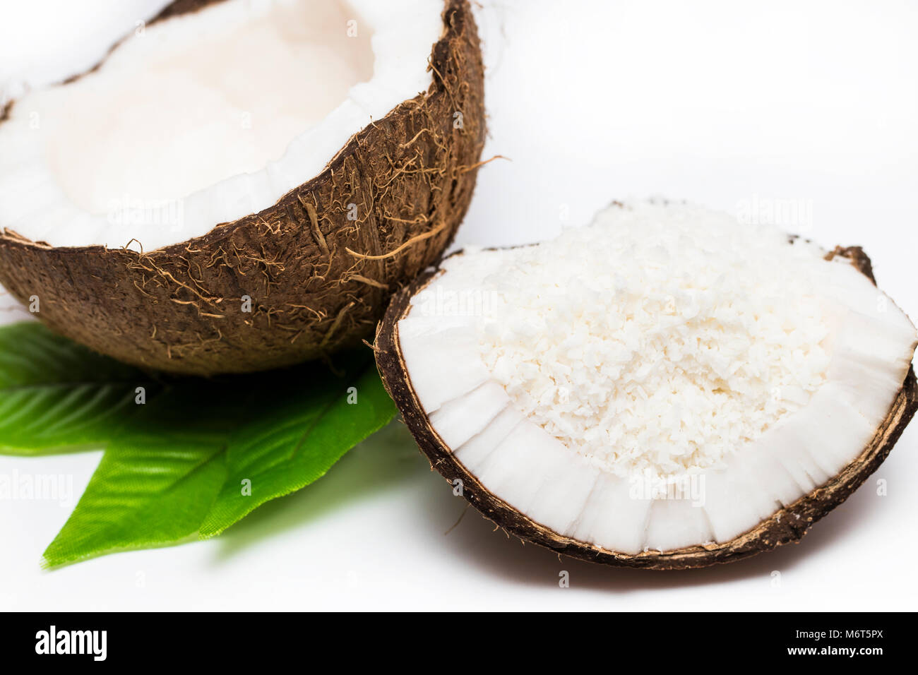 coconuts with coconuts flakes isolated on the white background Stock