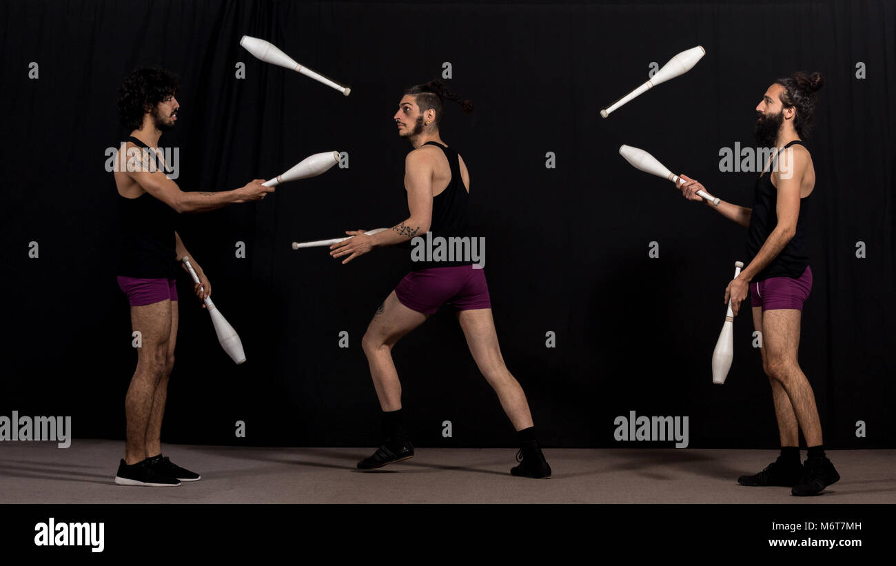 Circus jugglers during their batons show. Teamwork concept Stock Photo