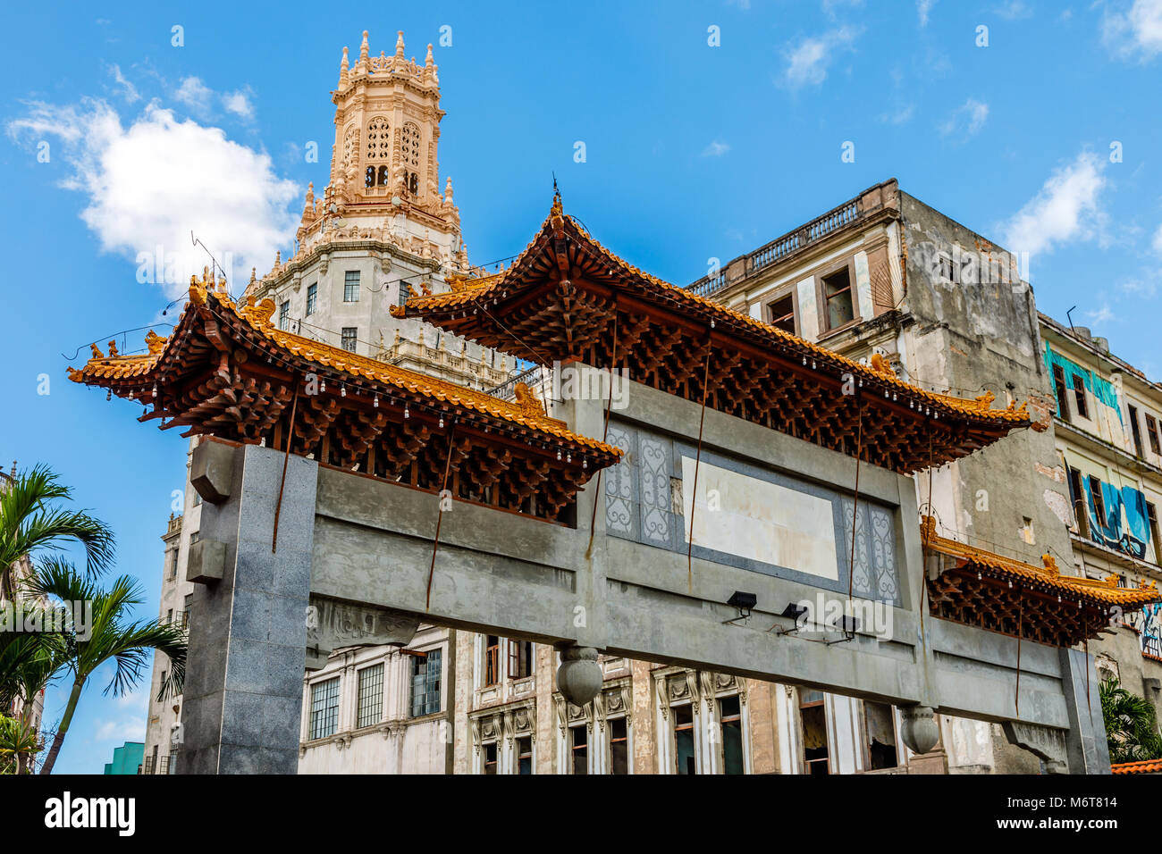 Abandoned chinatown arch and old slums in the background, Havana, Cuba Stock Photo