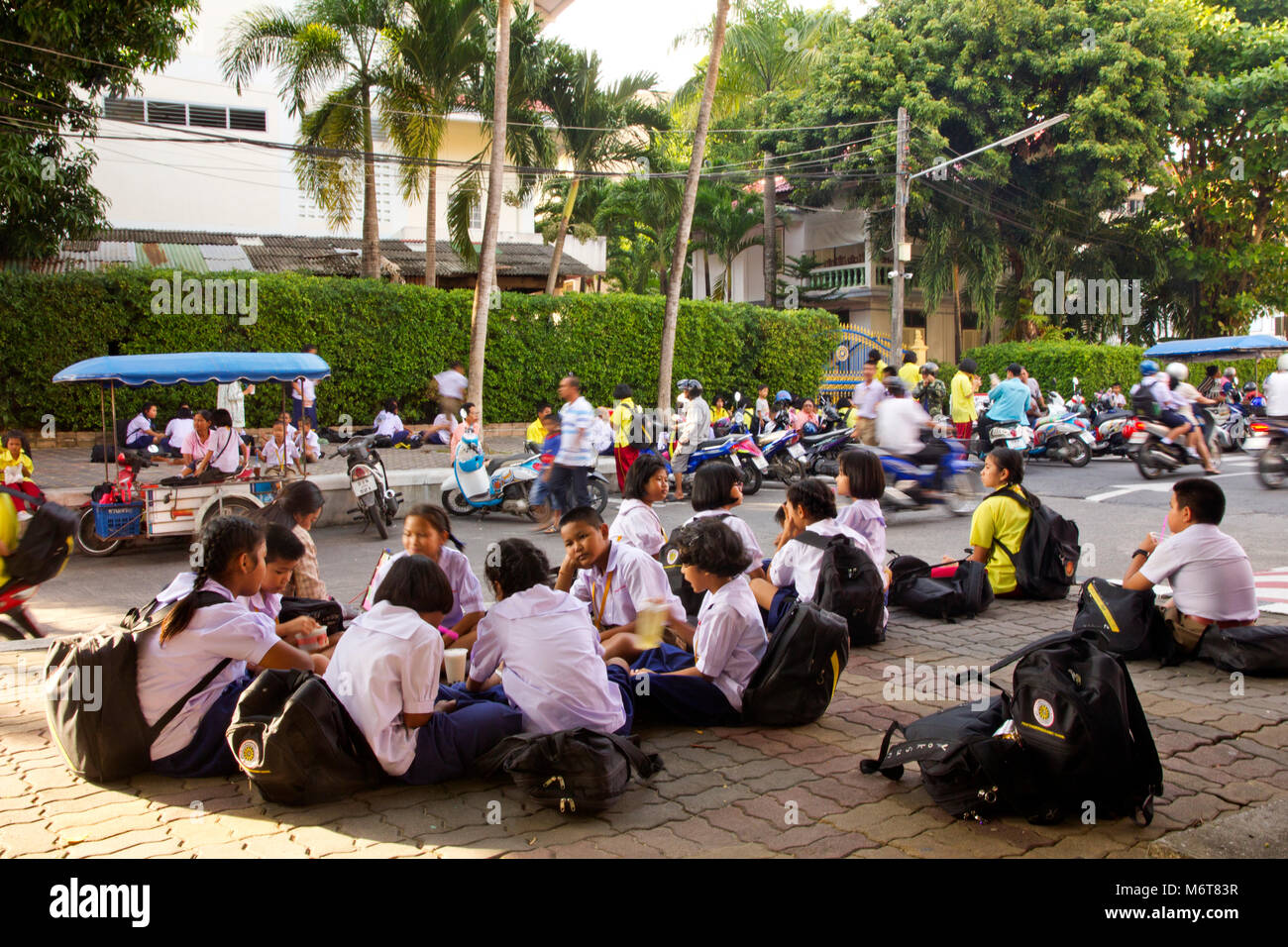 School children after school Wat Putta Mongkon Phuket town. Stock Photo