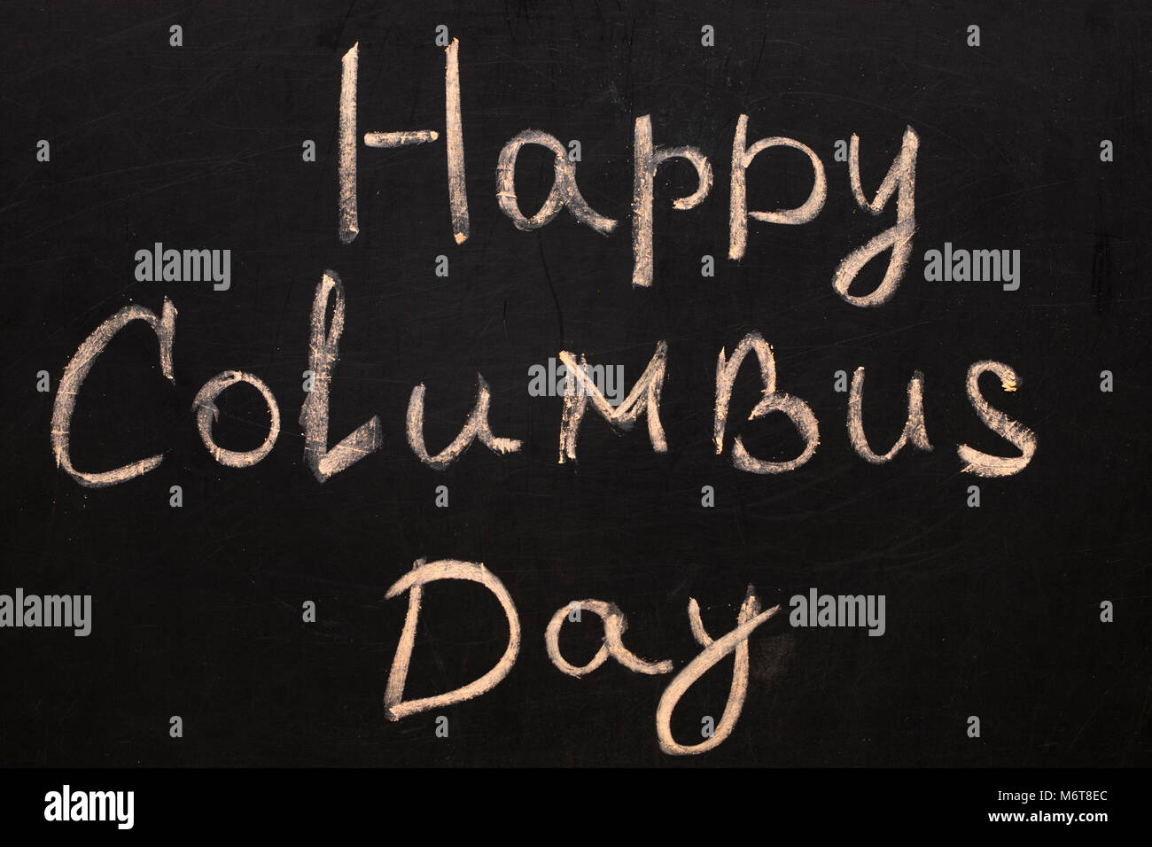 Happy Columbus Day.Inscription in chalk on a black chalkboard. Stock Photo