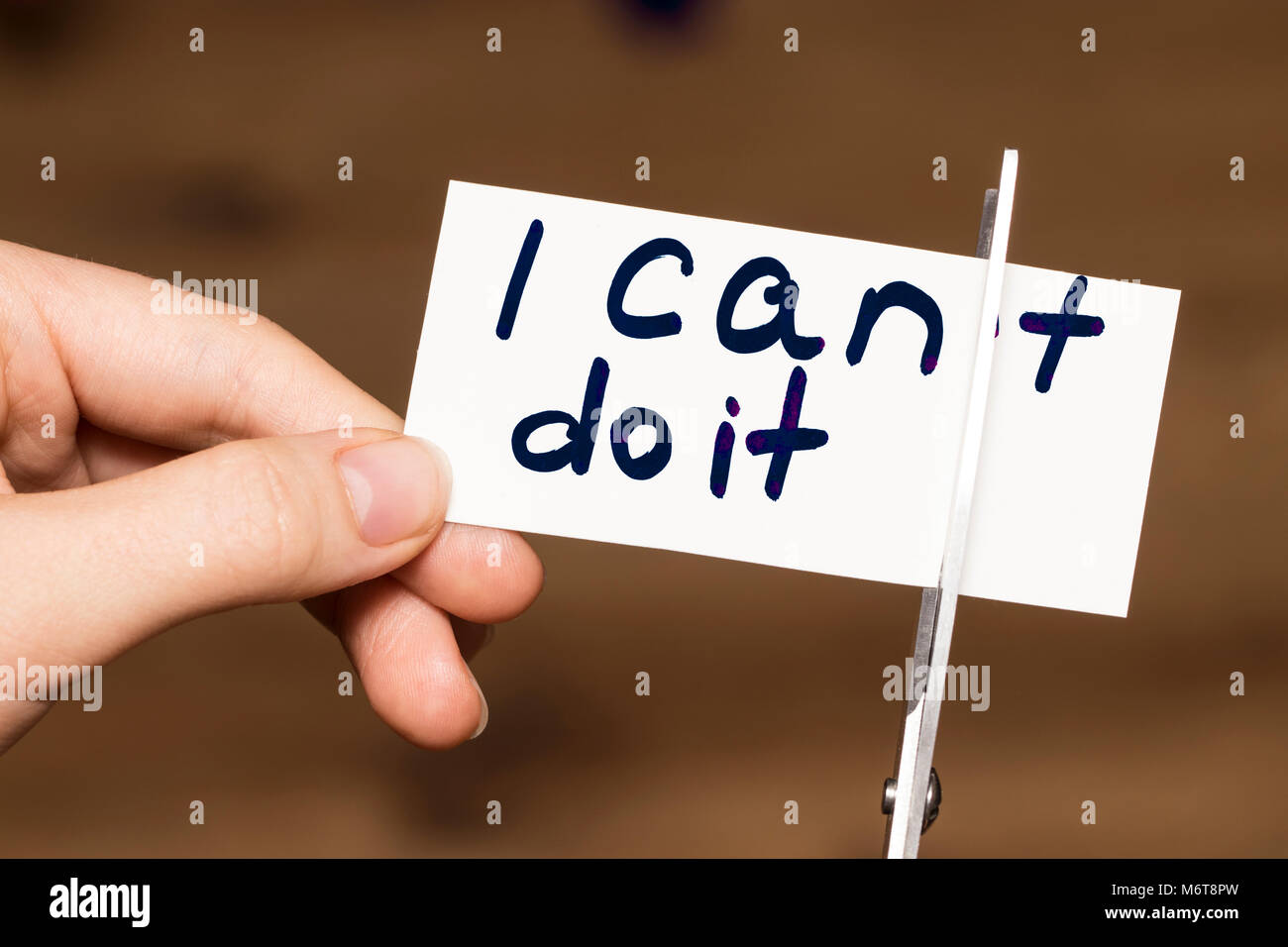 Man Using Scissors To Remove The Word Can T To Read I Can Do It Stock Photo Alamy