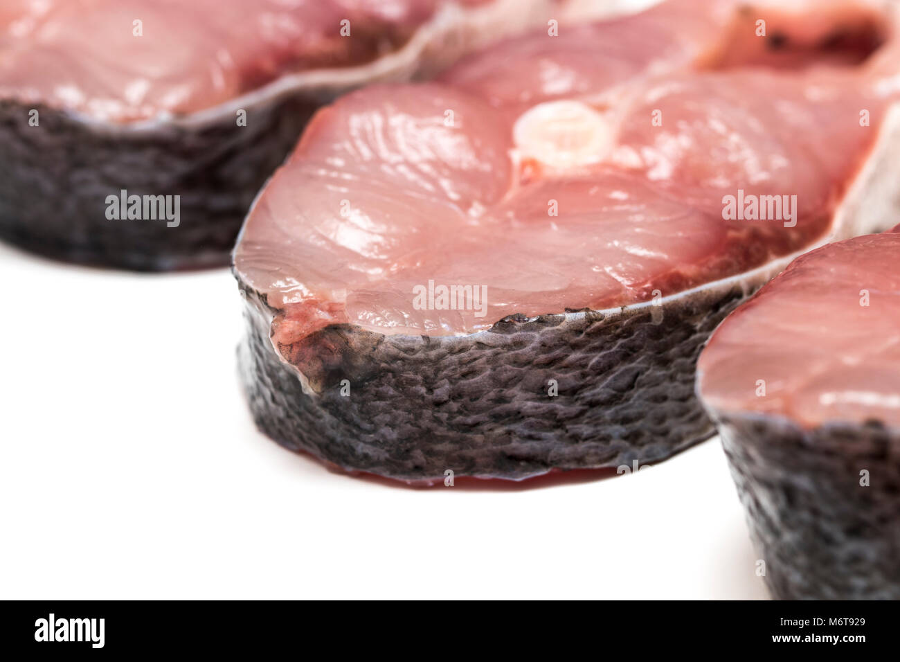 Raw steak of white fish on white background Stock Photo - Alamy