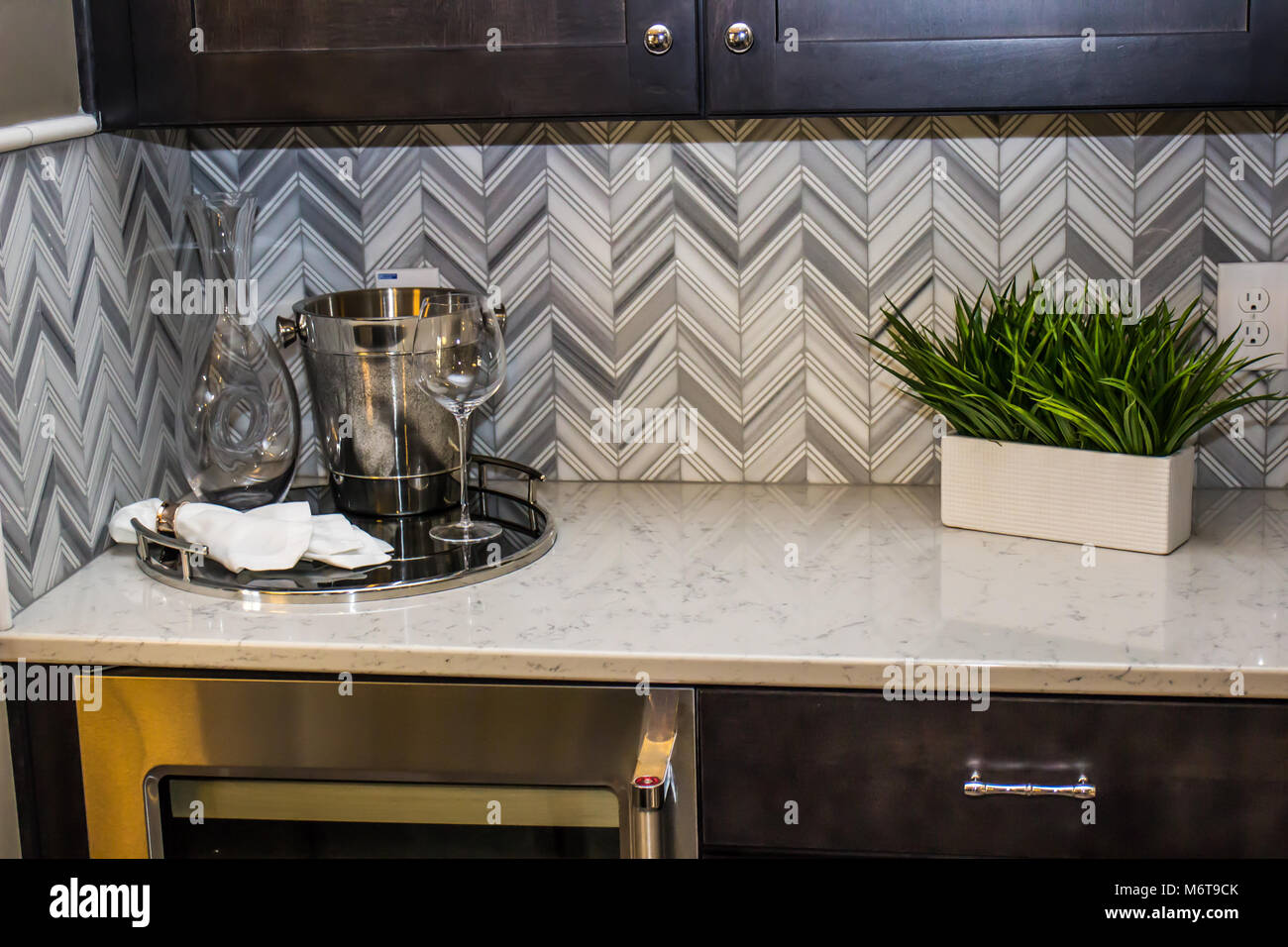Modern Kitchen Counter With Plant Ice Bucket Glasses Stock Photo Alamy
