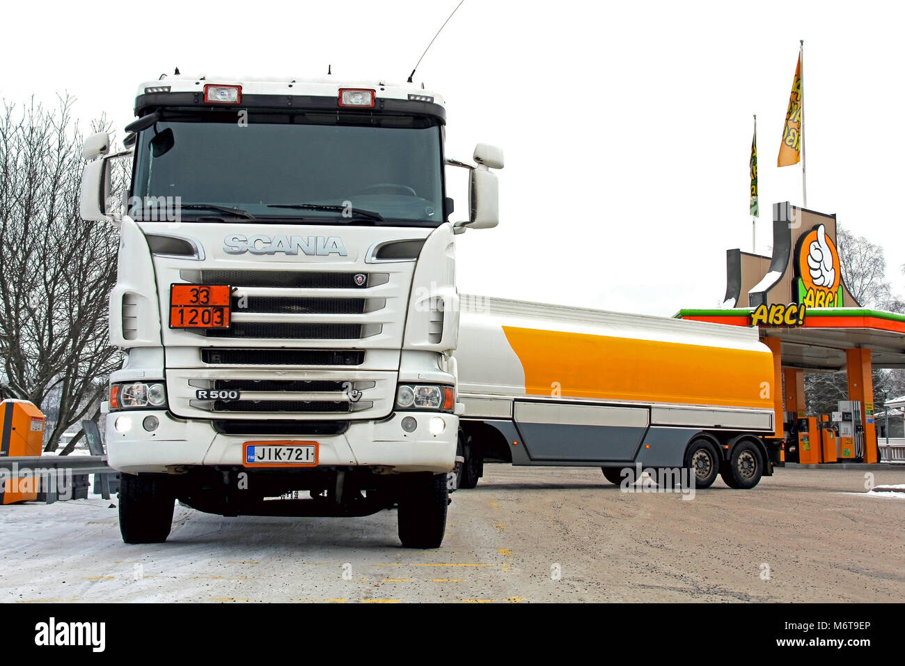 SOMERO, FINLAND - JANUARY 25, 2014: Scania R500 tanker truck unloads fuel at a petrol station. Due to higher excise taxes, the prices of fuel are on t Stock Photo