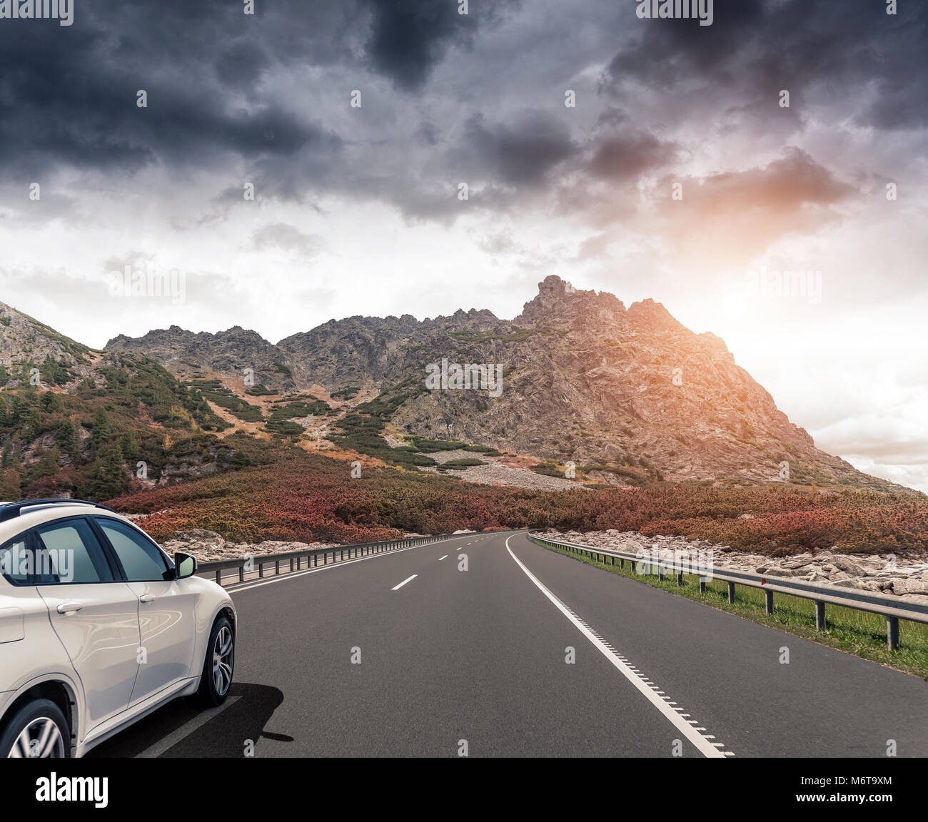 A white car rushing along a high-speed highway in the sun Stock Photo ...