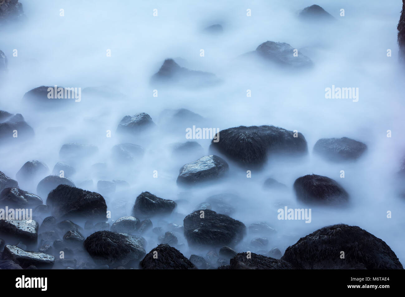 Stones in a stream with water blurred by long exposure using ND filter (Soft Focus), Iceland Stock Photo