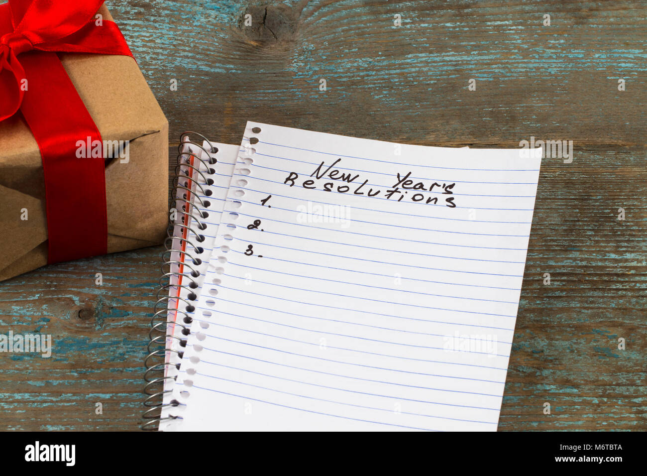 Resolutions text on notebook paper with gift box for business concept ...