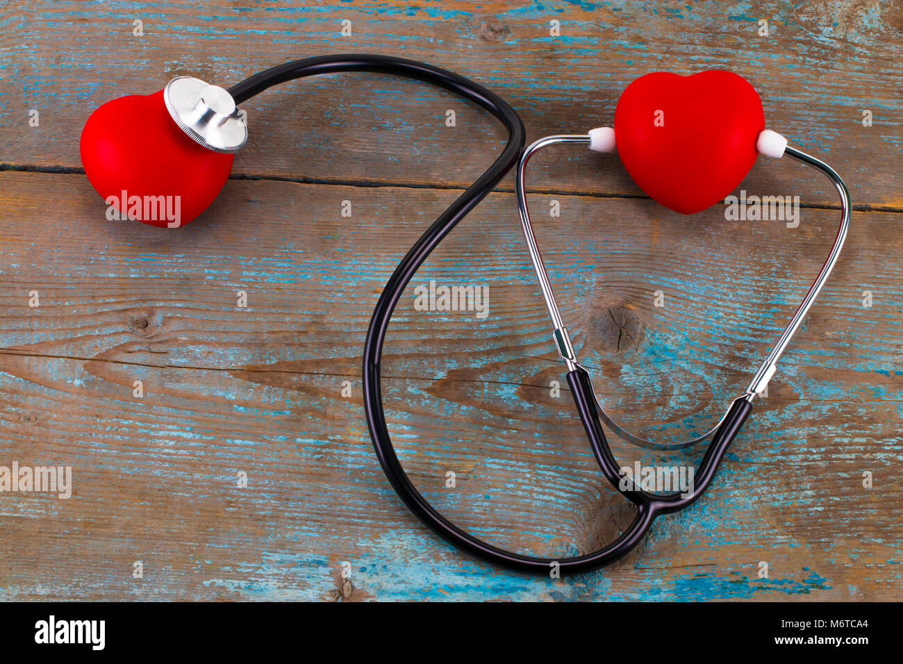 Stethoscope with red heart on a wood background Stock Photo - Alamy