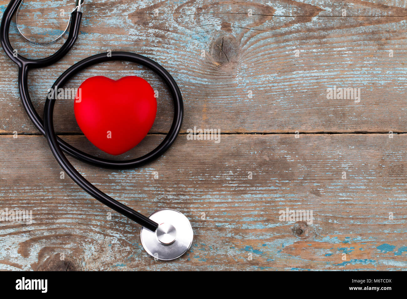 Stethoscope with red heart on a wood background.with copy space Stock ...