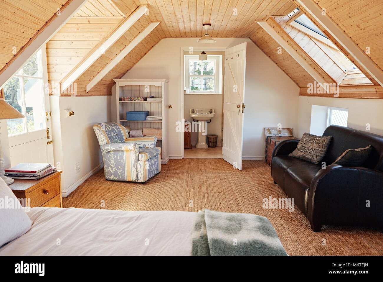 Interior of an attic bedroom with bathroom in a home Stock Photo