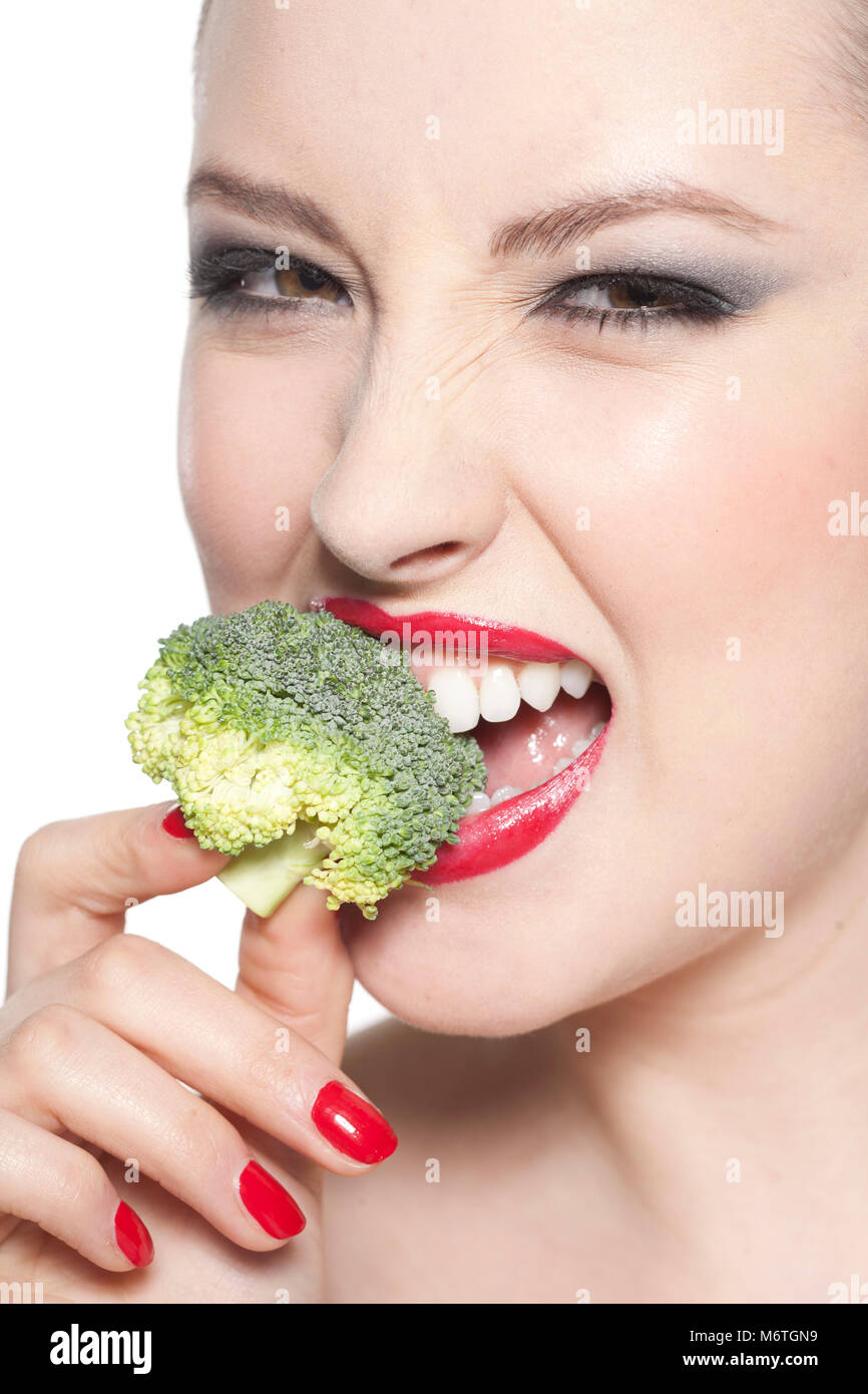 Woman eating broccoli Stock Photo